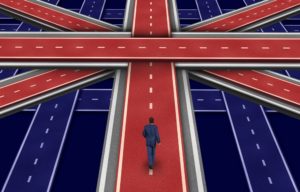 Man looking at crossroads with UK flag colours